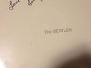 THE BEATLES WHITE ALBUM SIGNED BY LOU HARRISON AND STILL SEALED.