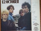 U2 October album authographed by all four band members.