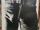 The Rolling Stones Sticky Fingers classic rock album with zipper Vinyl LP.